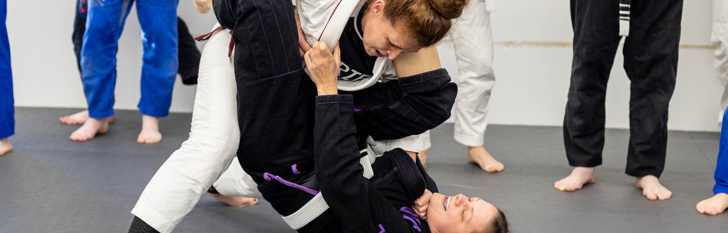 a pair of women practicing brazilian jiu jitsu at a Dunmore PA training gym
