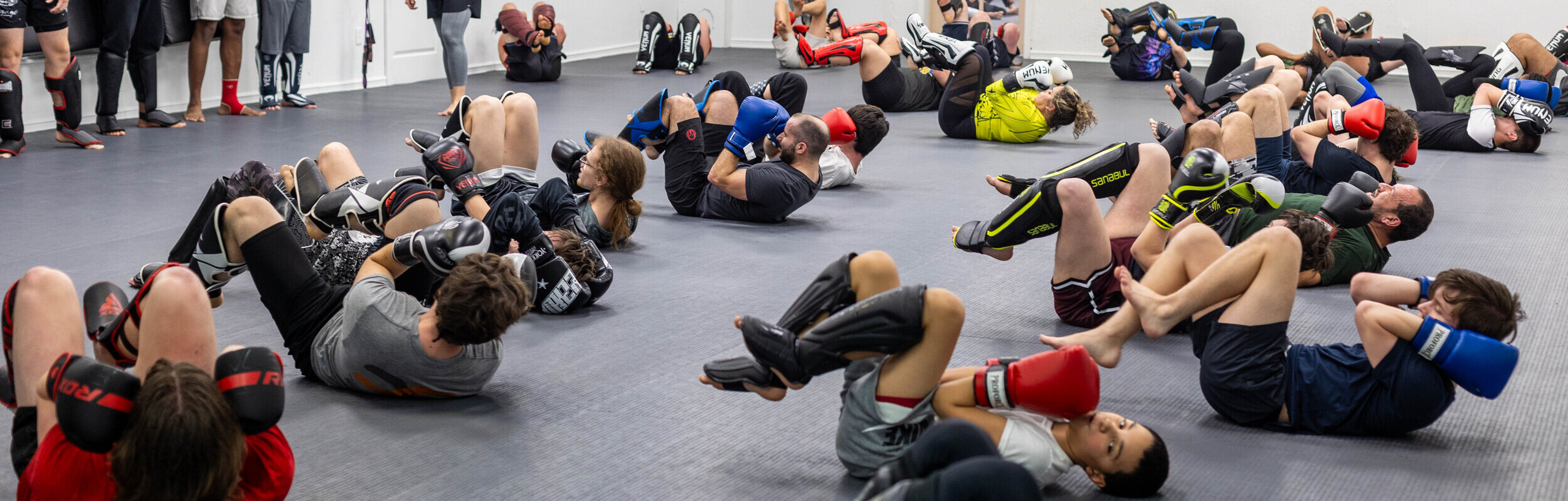 a group of mixed martial arts students practicing defense on the ground at Good Tree MMA in Dunmore PA